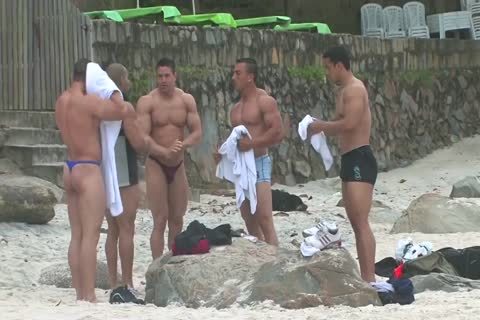 Bodybuilders In belts At Beach